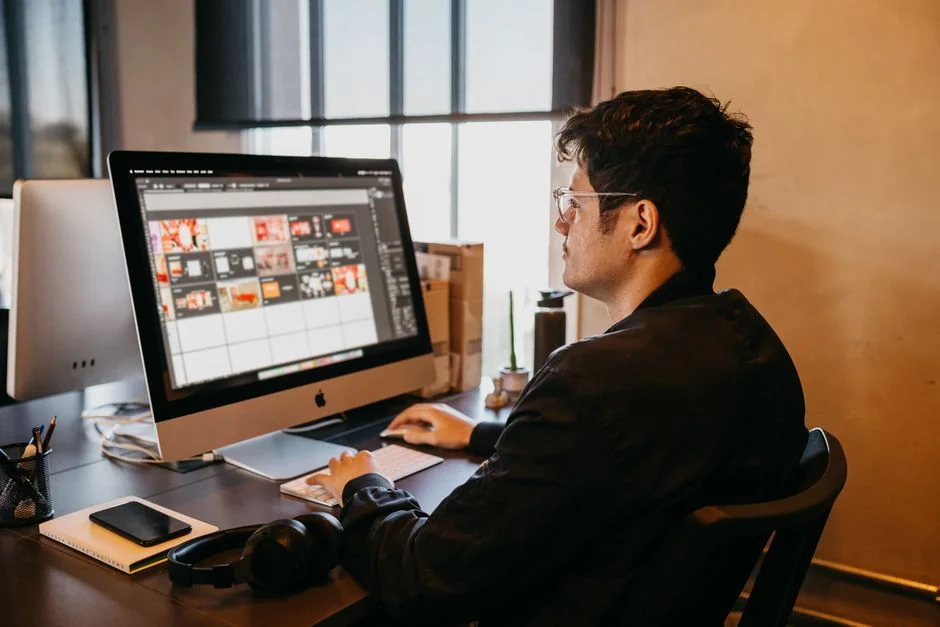 Woman engaged in software programming in a contemporary office setting with multiple screens.